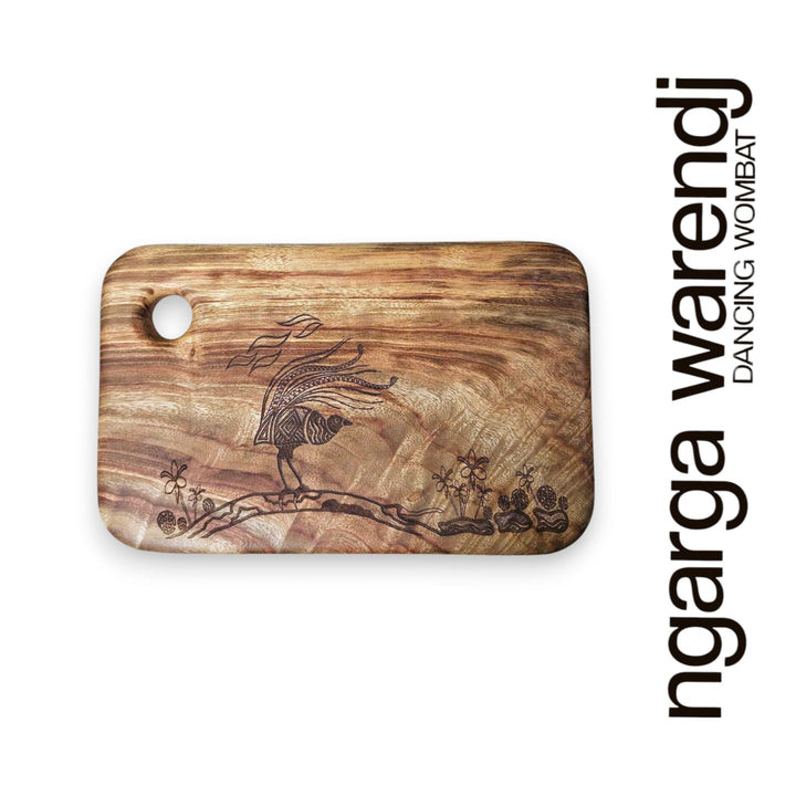 Wooden cutting board with engraved design on a white background, featuring the brand 'ngarga warendj'.