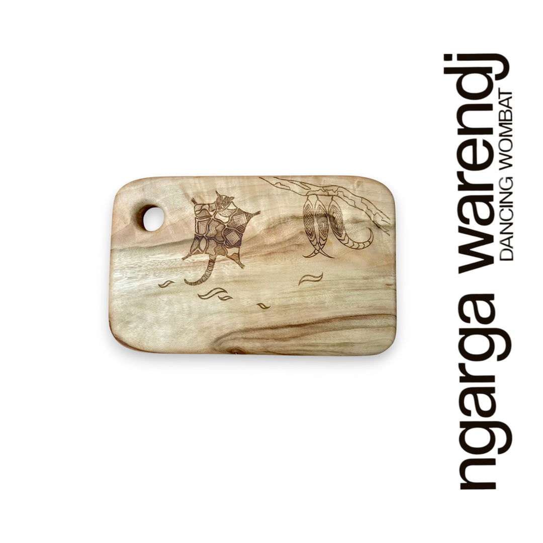 Wooden cutting board with engraving on a white background, featuring the brand 'ngarga warendj'.