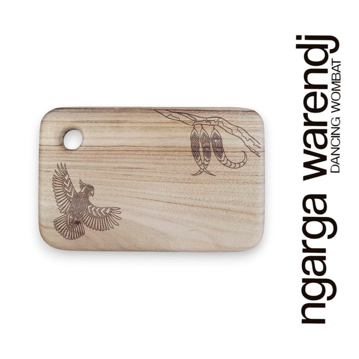Wooden cutting board with laser-engraved designs on a white background, featuring the brand 'ngarga warendj'.