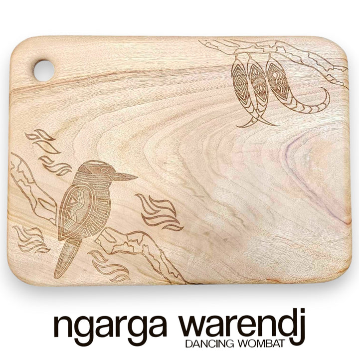 Wooden cutting board with laser-engraved design of a bird and text 'ngarga warendj Dancing Wombat' on a white background.