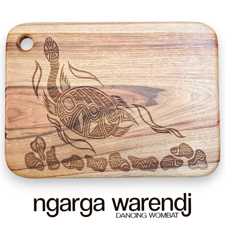 Wooden cutting board with turtle design and 'ngarga warendj' branding