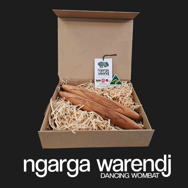 Box containing wooden items with 'ngarga warendj' branding on a black background