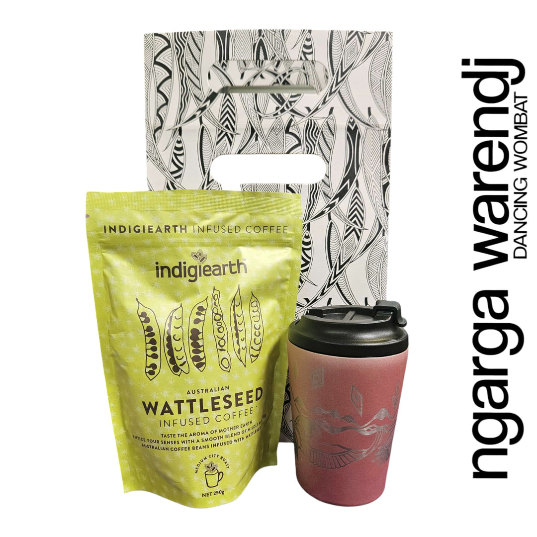 Indigiearth wattleseed infused coffee package with a pink reusable cup and a patterned bag on a white background.