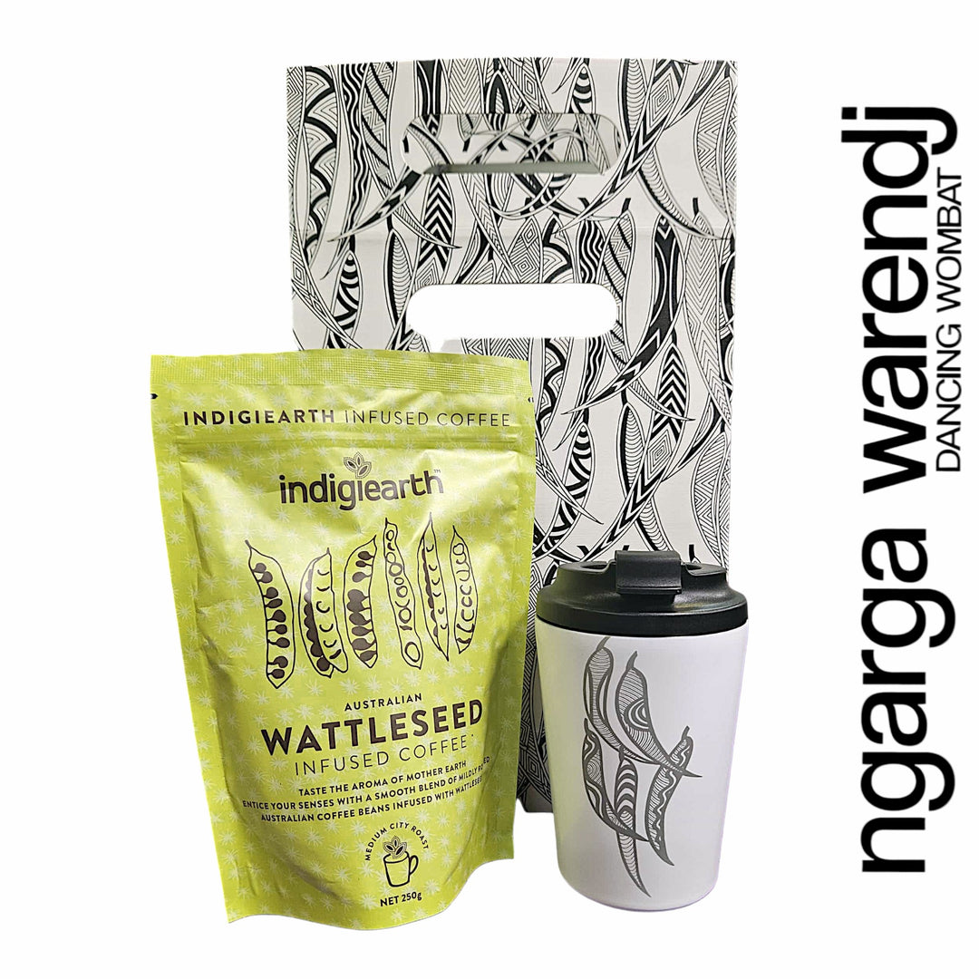 Indigiearth wattleseed infused coffee package with a white tumbler and decorative packaging on a white background.