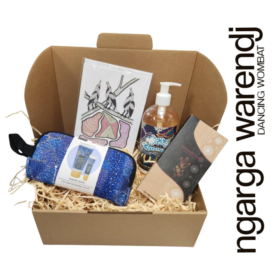 Gift box with various items including a pouch with hand cream and lip balm , hand and body wash, chocolate and card, branded 'ngarga warendj'.
