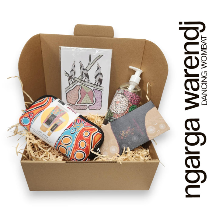 Gift box with various items including a pouch with hand cream and lip balm , hand and body wash, chocolate and card, branded 'ngarga warendj'.