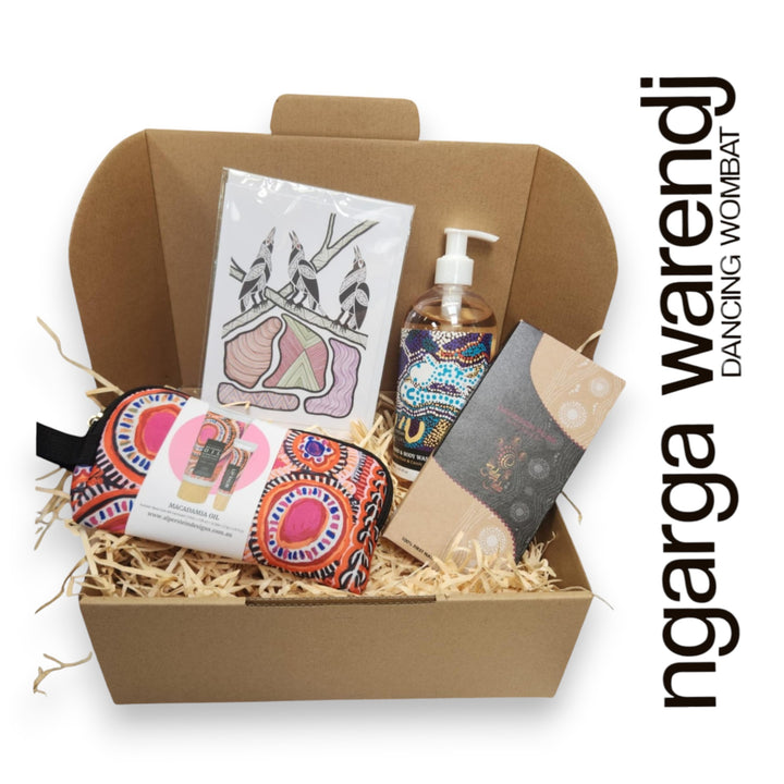 Gift box with various items including a pouch with hand cream and lip balm , hand and body wash, chocolate and card, branded 'ngarga warendj'.