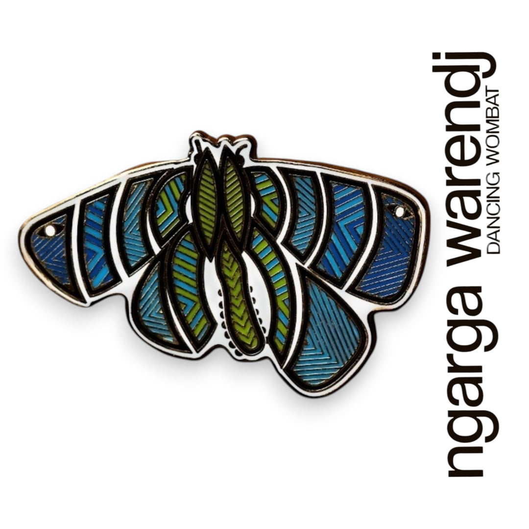 Decorative Bogong Moth with blue and green patterns on a white background, featuring the brand 'ngarga warendj'.