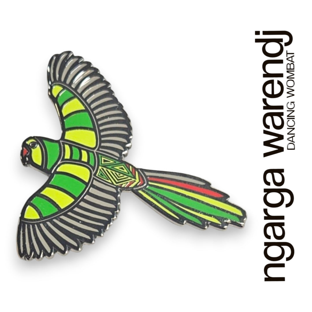 Colorful bird-shaped pin with 'ngarga warendj' branding on a white background