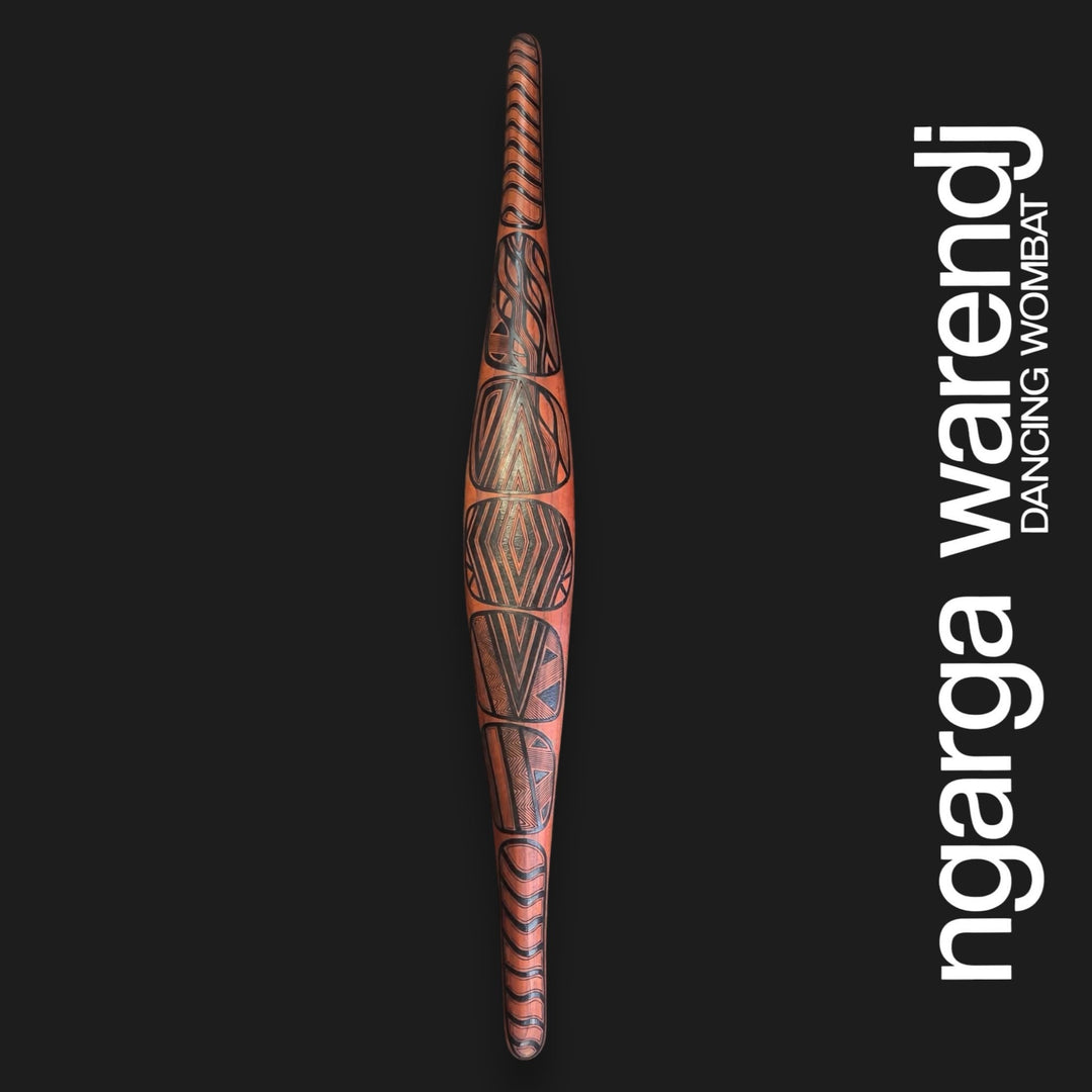 Front of large red cedar parrying shield with Gugra Possum Cloak Design, featuring dark geometric panels and curved lines.
