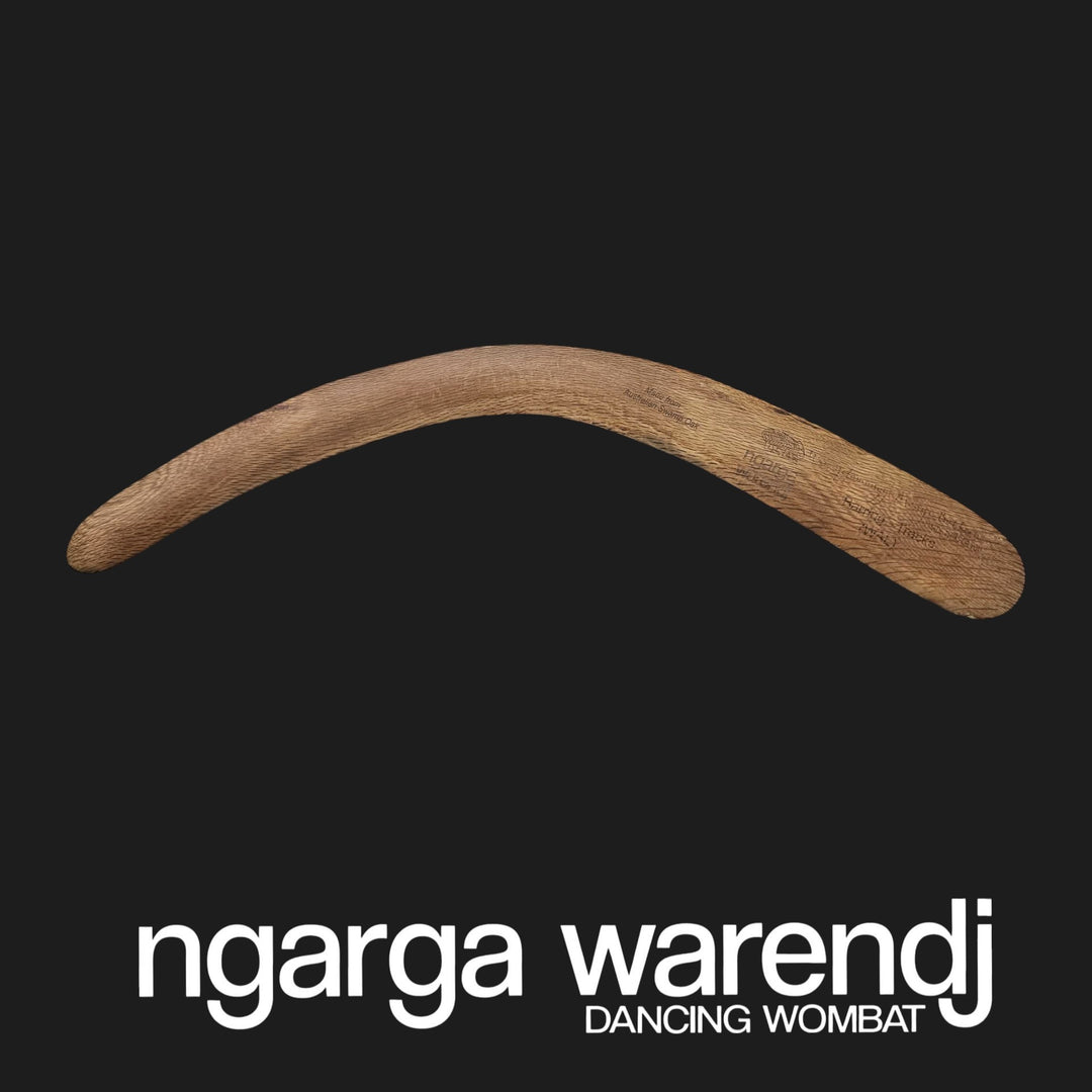 Wooden boomerang on a black background with 'ngarga warendj' branding.