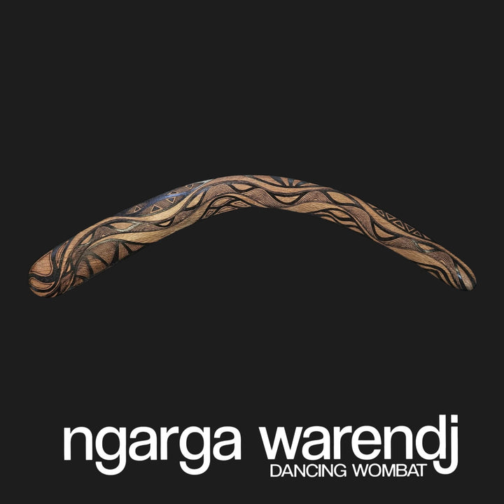 Decorative boomerang with intricate patterns on a black background, featuring the brand 'ngarga warendj'.