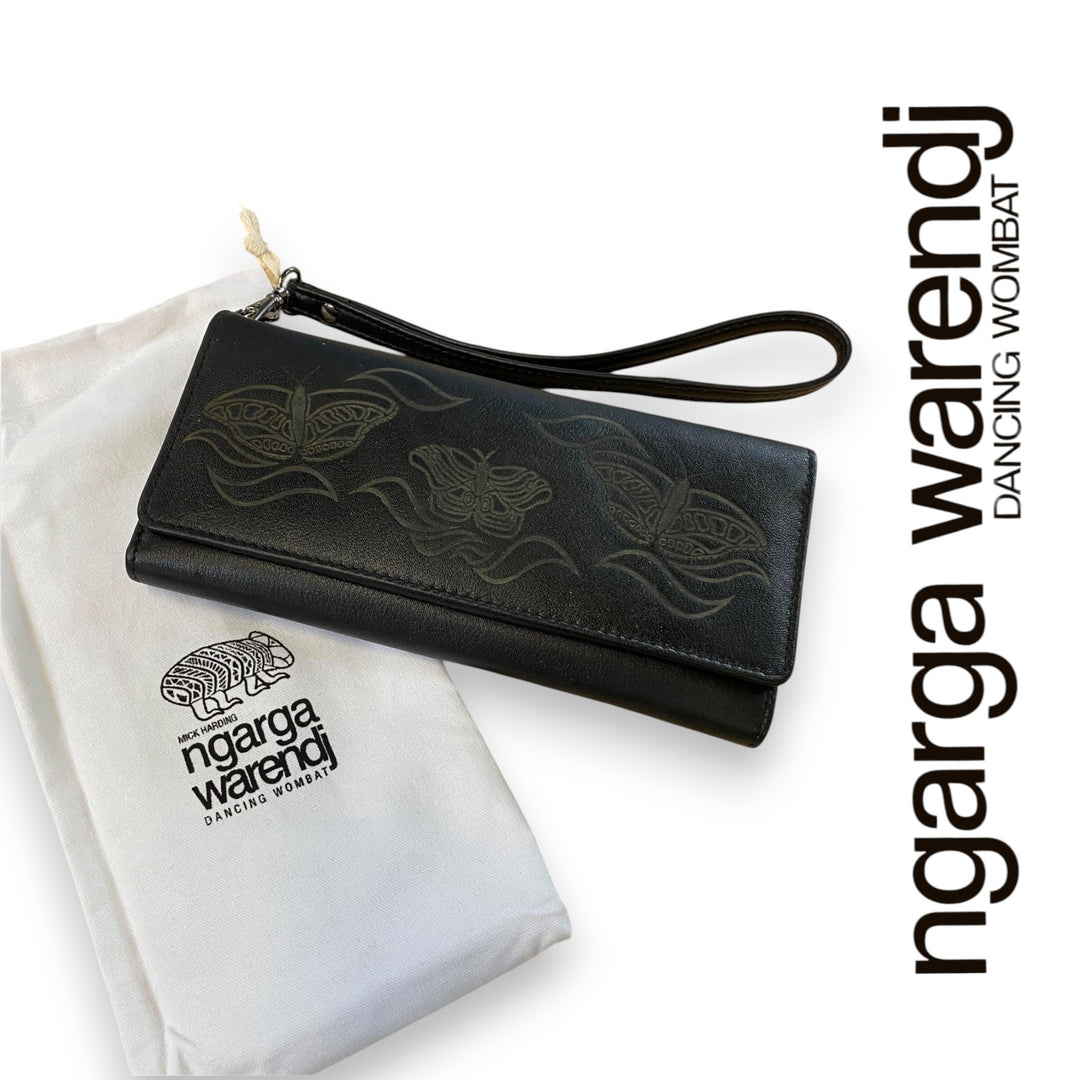 Black wallet with embossed designs on a white surface, featuring the 'ngarga Warendj' brand.
