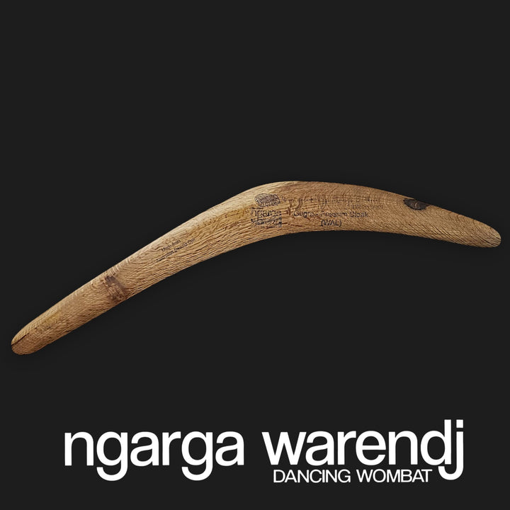 Wooden boomerang on a black background with 'ngarga warendj' branding.