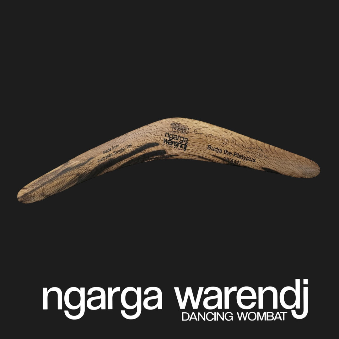 Wooden boomerang with 'ngarga warendj' branding on a black background