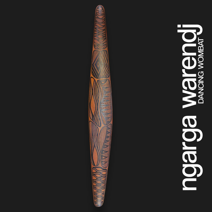 Front of large red cedar wall shield with Gugra Possum Cloak Design, featuring geometric panels and curved dark linework.