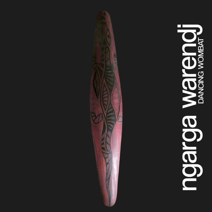 Front of medium Australian Red Cedar wall shield featuring Dhulin the goanna in black patterned linework with a long tail.