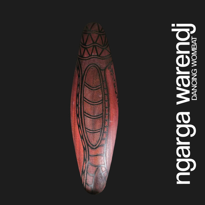 Front of small wide red cedar wall shield with carved Scar Tree design and dark linework on red cedar timber.