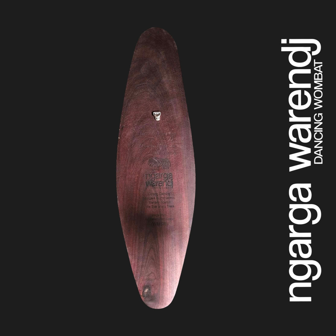Back of small wide red cedar wall shield showing the metal wall hanger, wood grain and Ngarga Warendj maker mark.