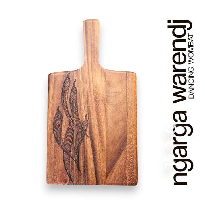 Wooden cutting board with engraved design on a white background, featuring the brand 'ngarga warendj'.