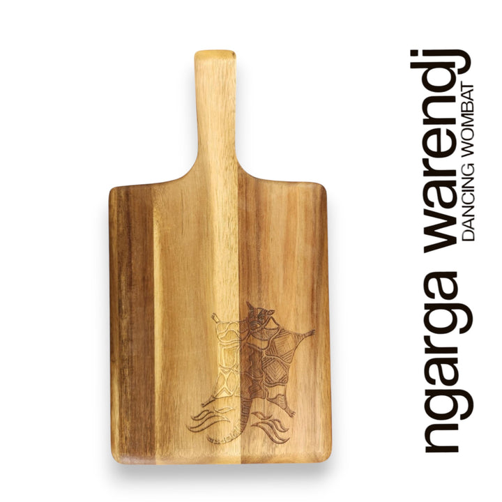 Wooden cutting board with a handle and engraved design on a white background, featuring the brand 'ngarga warendj'.