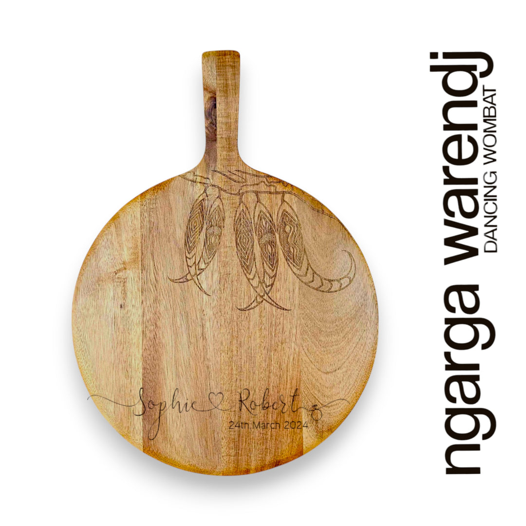 Wooden cutting board with engraved design and text, featuring the brand 'ngarga warendj'.