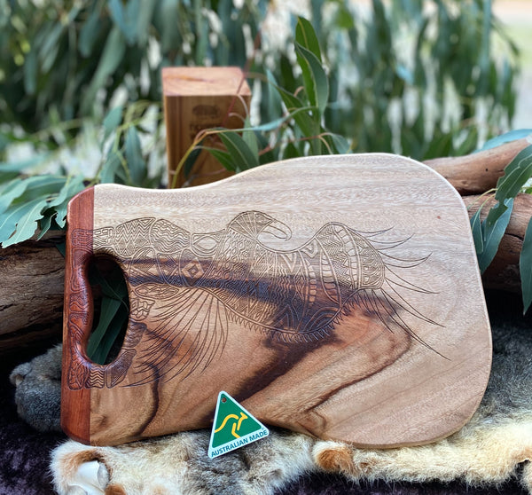 Bunjil the Wedge Tailed Eagle Board Made from Camphor Laurel with One Redgum Handle. Each board has its own distinct natural pattern and is embellished with a Bunjil Design by Ngarga Warendj - Dancing Wombat - based on the Traditional symbols of South Eastern Aboriginal Art. Your board comes with a card that gives the story of the artist and design.