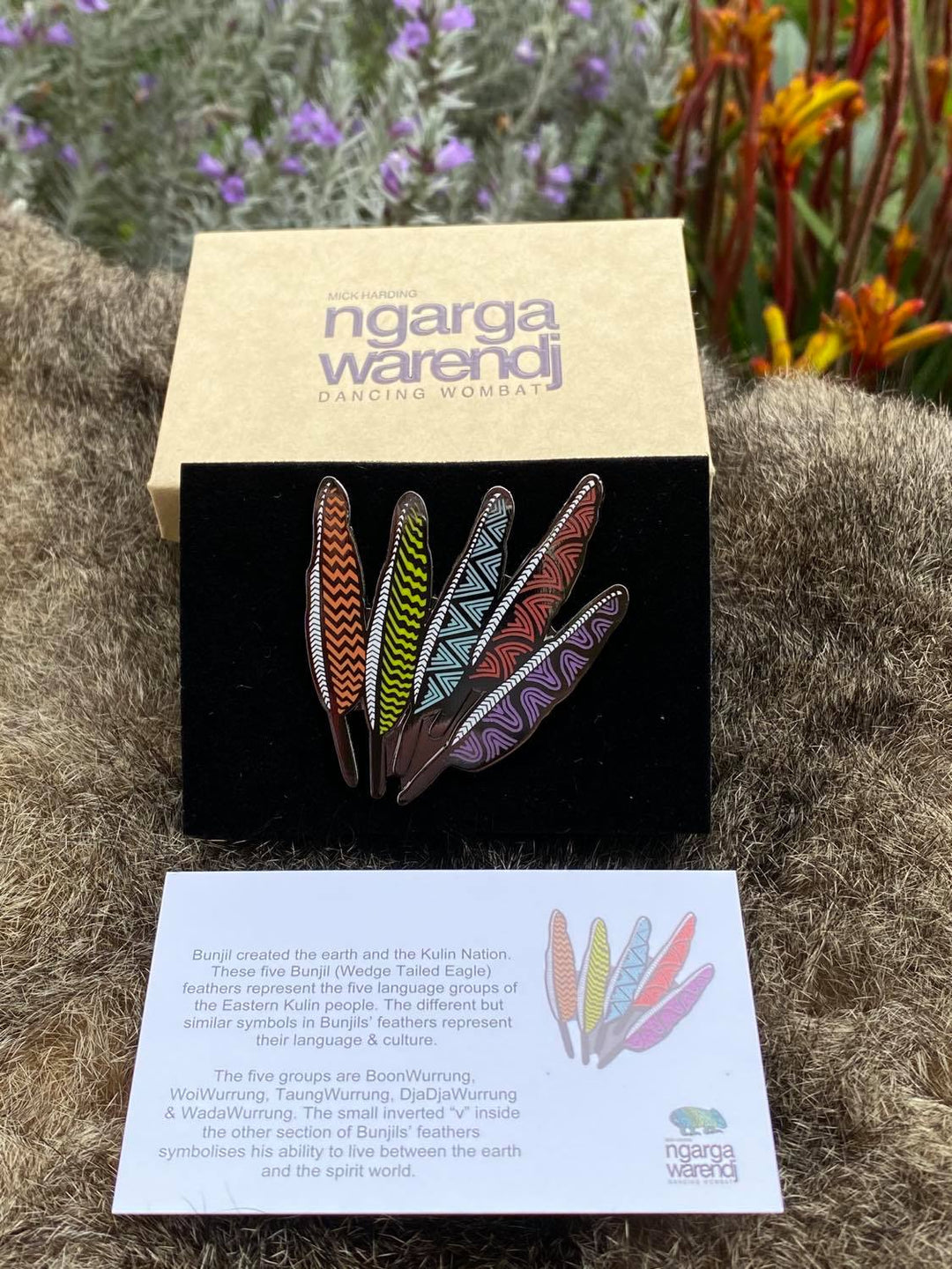 In its stylish box with magnetic closure, this pin is perfect for gift giving. This Lapel Pin featuring our Five Feathers design by Ngarga Warendj (Dancing Wombat), will add a finishing touch to any outfit. This design is inspired by Bunjil, Our creator ,with each of the feathers representing one of the five language groups of the Eastern Kulin Nations. Measures 55 mm x 53.7mm