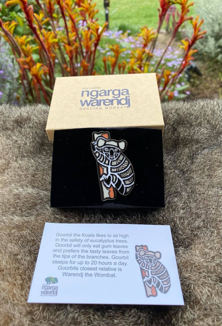 Add a finishing touch to any outfit, with this Lapel Pin featuring a Koala design by Ngarga Warendj Dancing Wombat Measures 55mm x 34mm  Presented in a stylish box with magnetic closure  Made from metal with enamel inlay Information card included - with information on the design and artist 