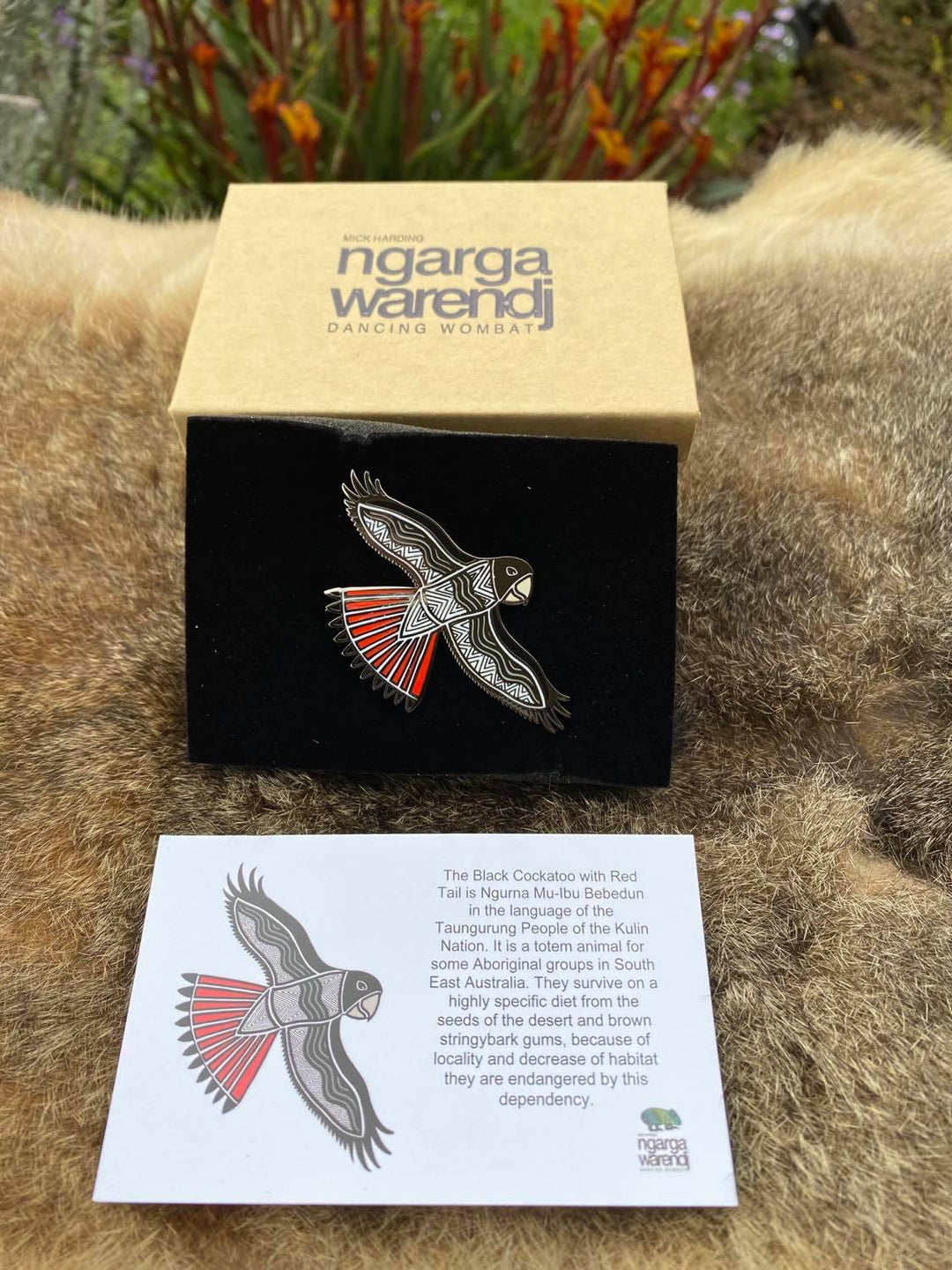 Add a finishing touch to any outfit, with this Lapel Pin featuring our Red Tailed Black Cockatoo design by Ngarga Warendj Dancing Wombat.