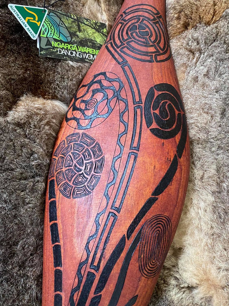 Traditionally malgarr ( shields ) were used with liyangayil ( fighting clubs) for hand to hand combat with our enemies. I have replicated the shape ofthese shields in my artwork. The Kwambee djak or common tree fern was used as a staple food by our old people during the Warendj (wombat season) or cooler months. Handcrafted in Australia from Australian Red Cedar by Mick Harding Ngarga Warendj Dancing Wombat