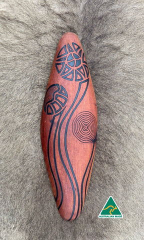 Traditionally malgarr ( shields ) were used with liyangayil ( fighting clubs) for hand to hand combat with our enemies. I have replicated the shape ofthese shields in my artwork. The Kwambee djak or common tree fern was used as a staple food by our old people during the Warendj (wombat season) or cooler months. Handcrafted in Australia from Australian Red Cedar by Mick Harding Ngarga Warendj Dancing Wombat